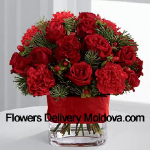 This Bouquet is a cheerful expression of all the merry moments this holiday season has to offer. Bright red spray roses, red mini carnations, burgundy mini carnations, red hypericum berries and assorted holiday greens are elegantly arranged in a clear glass vase bedecked with a rich red ribbon to create a holiday greeting in the spirit of this wondrous season of giving and gratitude. (Please Note That We Reserve The Right To Substitute Any Product With A Suitable Product Of Equal Value In Case Of Non-Availability Of A Certain Product)